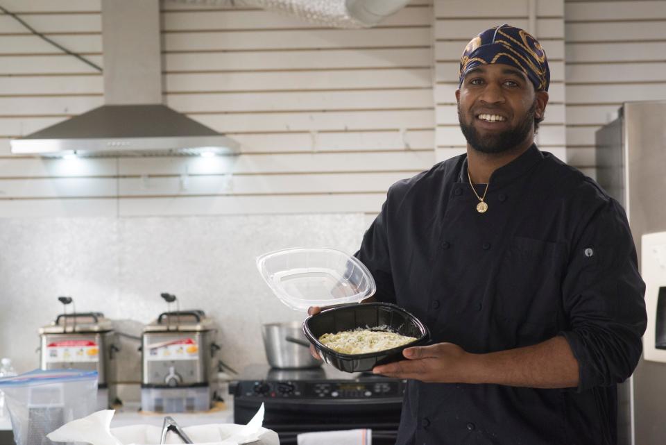 A fresh plate of alfredo is presented by LaVale Jackson inside his delivery and carryout-only restaurant 7.8.5 Kitchen. Jackson opened in August to serve soul food to his hometown after seeing the rise of pop-up and ghost kitchens.