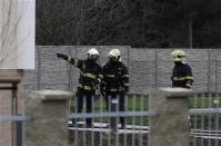 Firefighters search an area after an explosion in Prague January 1, 2014.