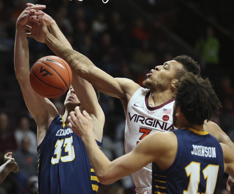 Virginia Tech's Wabissa Bede (3) battles for a rebound with Chattanooga's Stefan Kenic (33) and Rod Johnson (11) in the first half of an NCAA college basketball game, Wednesday, Dec. 11, 2019, in Blacksburg, Va. (Matt Gentry/The Roanoke Times via AP)