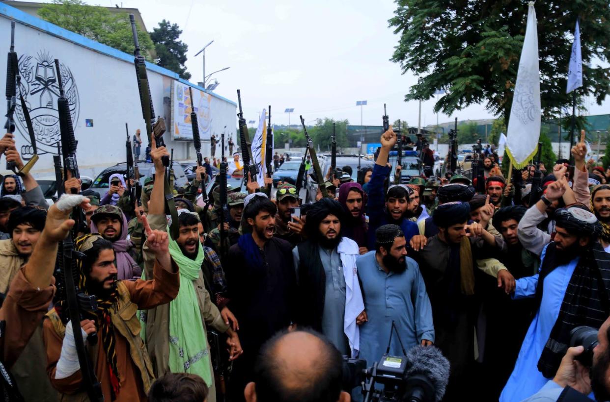 Taliban and their supporters gather near the building of the former US embassy as they celebrate the first anniversary of taking over the government in Kabul, EPA