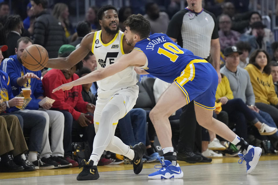 Utah Jazz guard Malik Beasley, left, looks to pass the ball while being defended by Golden State Warriors guard Ty Jerome (10) during the first half of an NBA basketball game in San Francisco, Wednesday, Dec. 28, 2022. (AP Photo/Jeff Chiu)