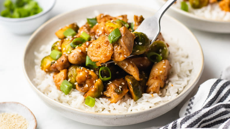 Chicken and Brussels sprouts stir fry forked out of bowl