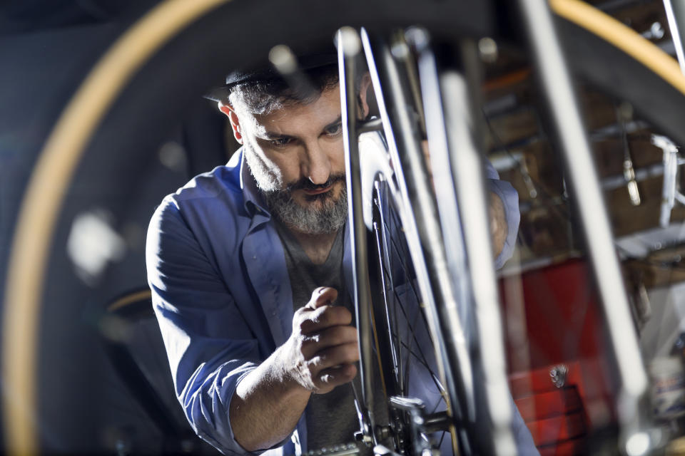 Man working on bicycle in workshop