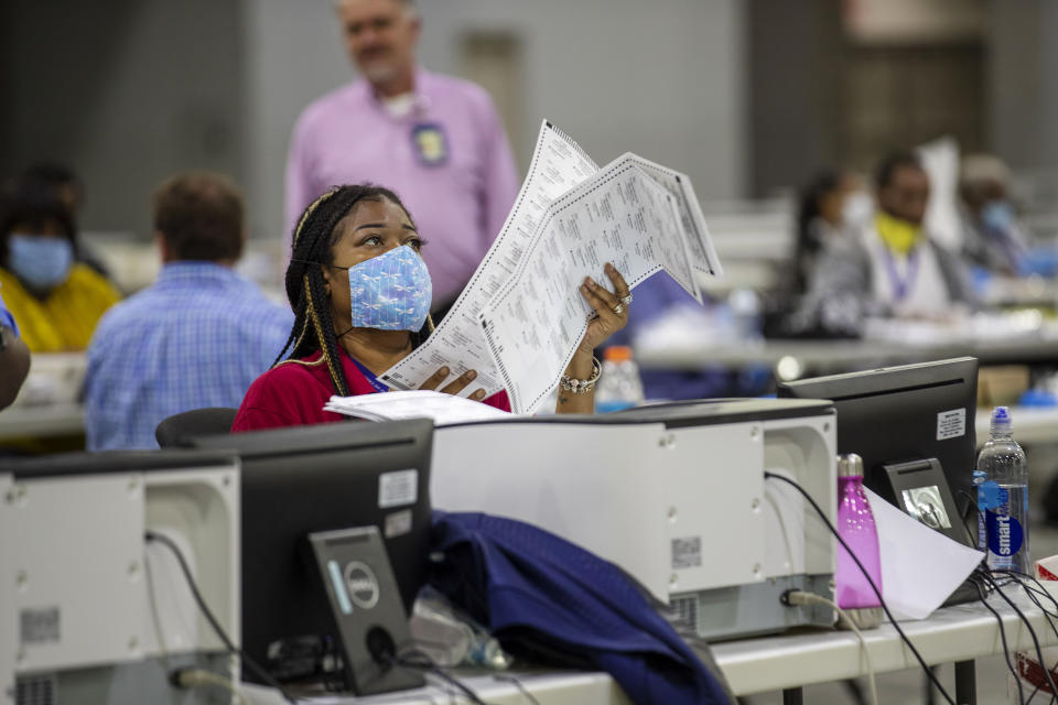 Fulton County employee Shaye Moss scans mail-in paper ballots at the Georgia World Congress Center during the Georgia primary elections in Atlanta on Tuesday, June 9, 2020. (Alyssa Pointer/Atlanta Journal-Constitution via AP)