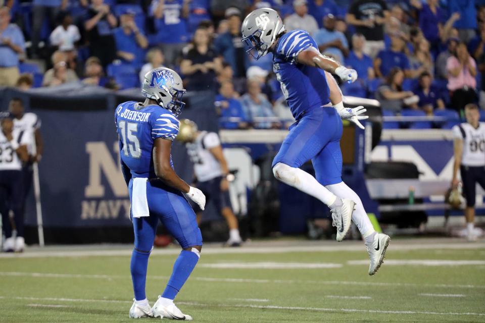 Oct 14, 2021; Memphis, Tennessee, USA; Memphis Tigers defensive back Quindell Johnson (15) and linebacker Cole Mashburn (46) celebrate a sack by Johnson at Liberty Bowl Memorial Stadium. Mandatory Credit: Petre Thomas-USA TODAY Sports