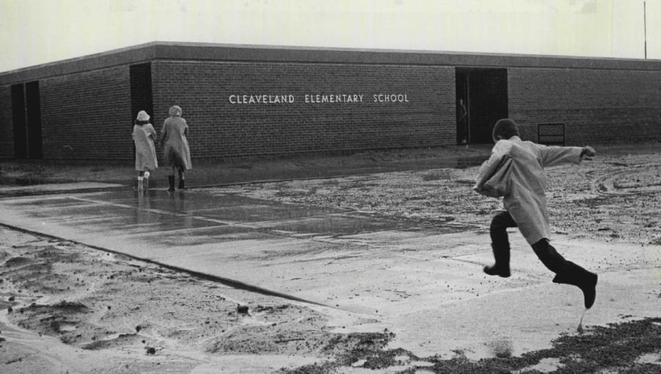 A 1962 photo of a student running into Cleaveland Elementary School.