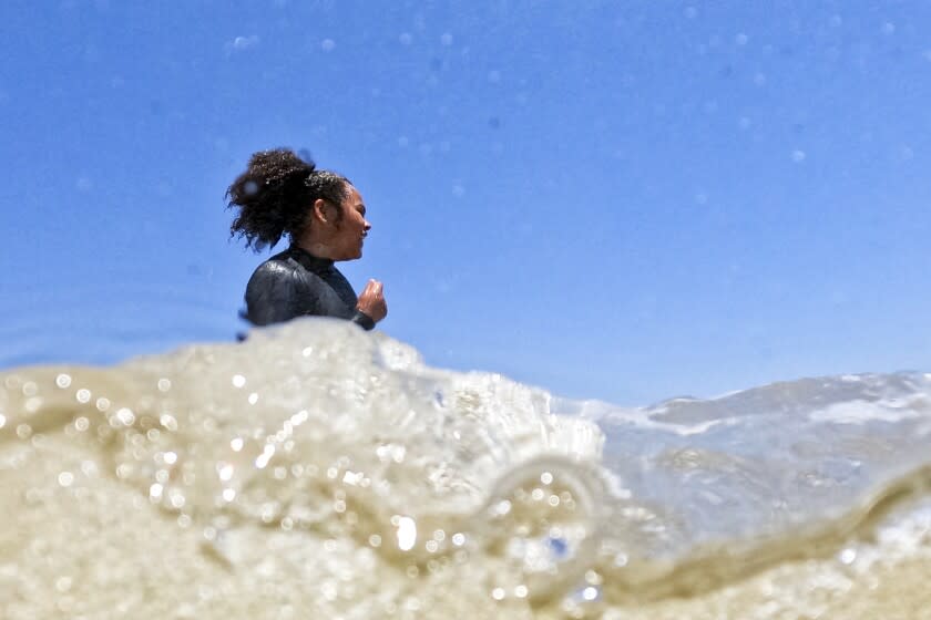 Participants in a Los Courage Camp event play in the water just before taking their boards in to surf at First Point