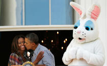 <p>The couple get in the Easter spirit by sharing a kiss by the Easter Bunny.<em> [Photo: Getty]</em> </p>