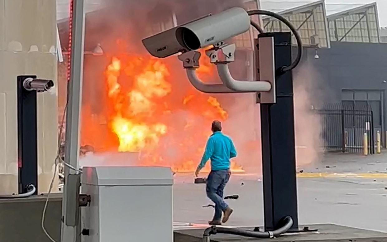 A vehicle burns at the Rainbow Bridge U.S. border crossing with Canada, in Niagara Falls, New York