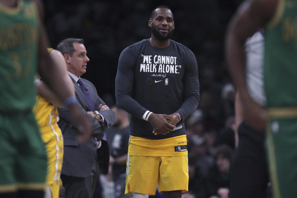 Los Angeles Lakers forward LeBron James talks with head coach Frank Vogel during the fourth quarter of an NBA basketball game against the Boston Celtics in Boston, Monday, Jan. 20, 2020. The Celtics defeated the Lakers 139-107. (AP Photo/Charles Krupa)