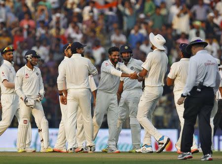 India's Ravindra Jadeja (C) is congratulated by his teammates after taking the wicket of South Africa's Imran Tahir (unseen) during the first day of their third test cricket match in Nagpur, India, November 25, 2015. REUTERS/Amit Dave