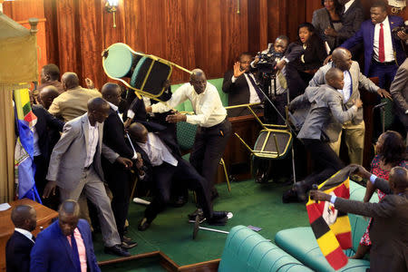 Ugandan opposition lawmakers fight with plain-clothes security personnel in the parliament while protesting a proposed age limit amendment bill debate to change the constitution for the extension of the president's rule, in Kampala, Uganda September 27, 2017. REUTERS/James Akena