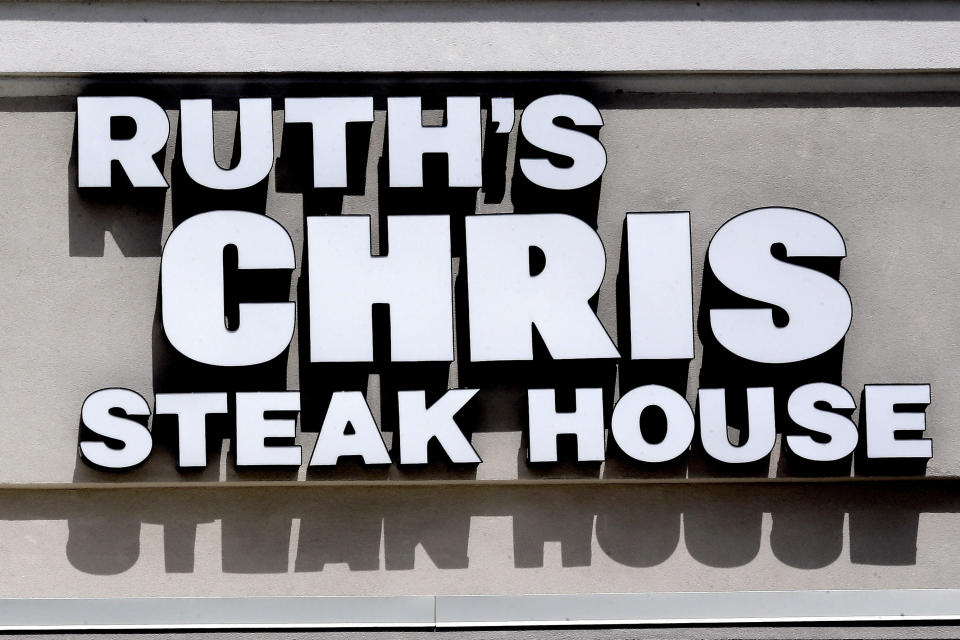 Signage at a Ruth's Chris Steak House restaurant is shown in Durham, N.C., Tuesday, July 7, 2020. The restaurant is among big corporate names on the government’s list of 650,000 recipients of coronavirus relief loans despite the controversy that prompted other high-profile businesses to return billions of dollars in loans. (AP Photo/Gerry Broome)