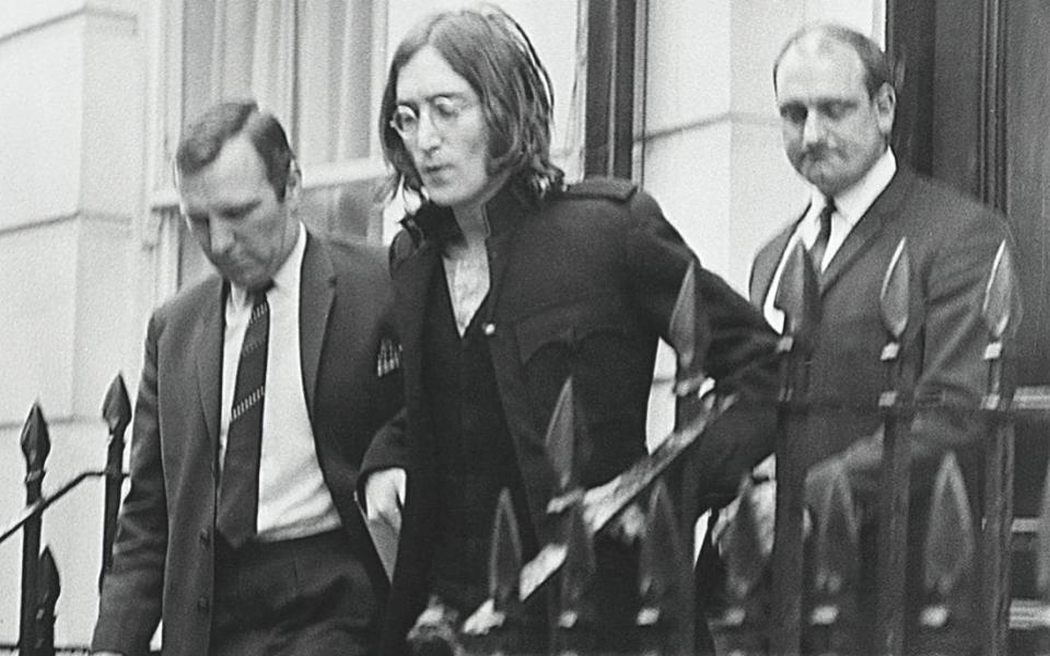 Pilcher (left) arresting John Lennon in London in 1968 - Getty images