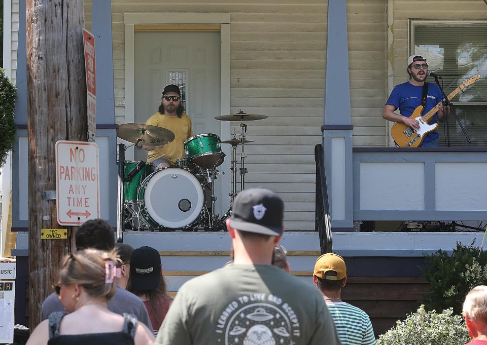 Sister Sandy band members Bob Wesley, left, and Chris Joecken perform at a Dodge Avenue home in Highland Square during the annual Porch Rokr Festival on Saturday in Akron.