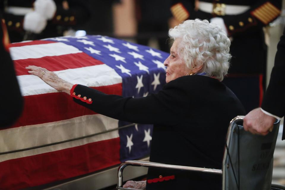 Annie Glenn touches her husband John Glenn's casket as he lies in honor, Friday, Dec. 16, 2016, in Columbus, Ohio. Glenn's home state and the nation began saying goodbye to the famed astronaut who died last week at the age of 95. (AP Photo/John Minchillo)