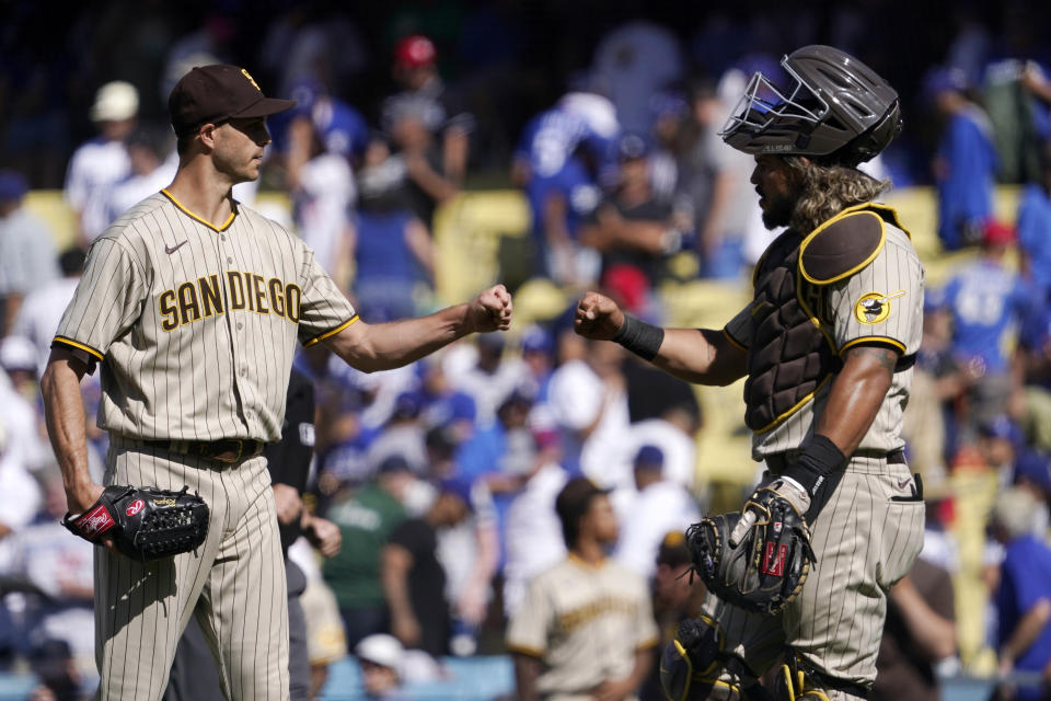 San Diego Padres relief pitcher Taylor Rogers, left, and catcher Jorge Alfaro congratulate each other after the Padres defeated the Los Angeles Dodgers 4-2 in a baseball game Sunday, July 3, 2022, in Los Angeles. (AP Photo/Mark J. Terrill)