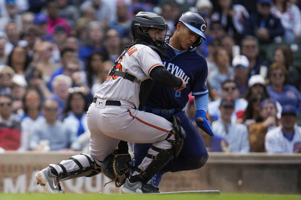 Chicago Cubs' Miguel Amaya, right, is tagged out at home by Baltimore Orioles catcher Adley Rutschman during the sixth inning of a baseball game Friday, June 16, 2023, in Chicago. (AP Photo/Erin Hooley)