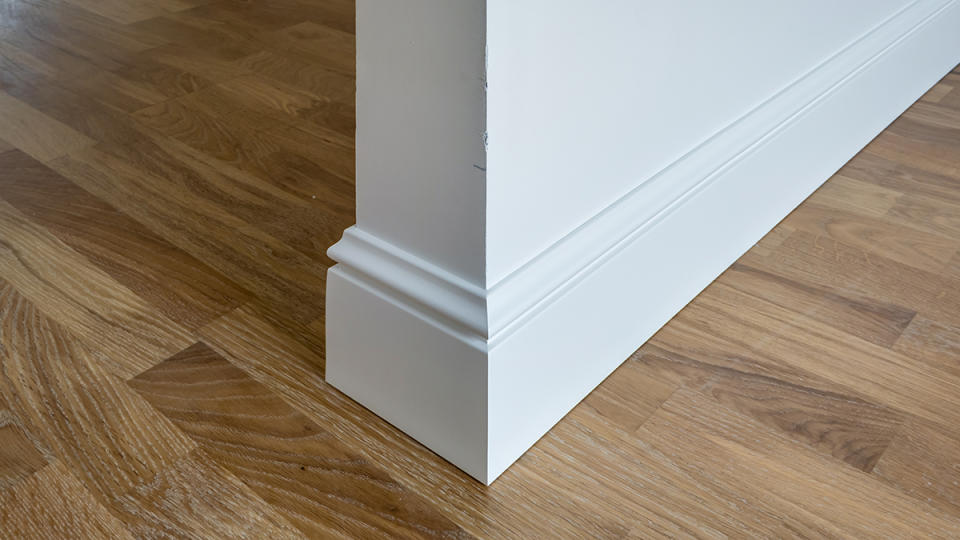 Intricate baseboard that needs cleaning