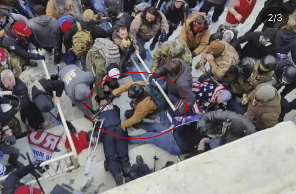 This image from police body-worn camera video, contained and annotated in the Justice Department's government's sentencing memorandum supporting the sentencing of Jeffrey Sabol, shows Sabol at the U.S. Capitol on Jan. 6, 2021, in Washington. During the course of an attack on police officers, Sabol ripped the baton out of the hands of a fallen officer, leaving him unable to defend himself against assaults by other rioters. Sabol then helped his co-defendants drag a second officer into the crowd, where that officer was also beaten by rioters. (Department of Justice via AP)