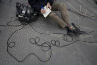 FILE - In this March 24, 2021, file photo WCBS Newsradio 880 reporter Peter Haskell wears New York subway map themed socks while taking notes during a news conference in New York. A new study of people's attitudes toward the press finds that distrust goes deeper than just partisanship and down to how journalists define their mission. Americans want their journalists to be more than watchdogs. (AP Photo/Mary Altaffer, File)