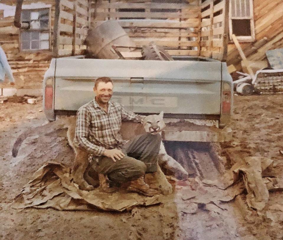 John Simpson, a family friend of the Huffmans, with a mountain lion harvested in the mountains near Regina, New Mexico, in 1969.