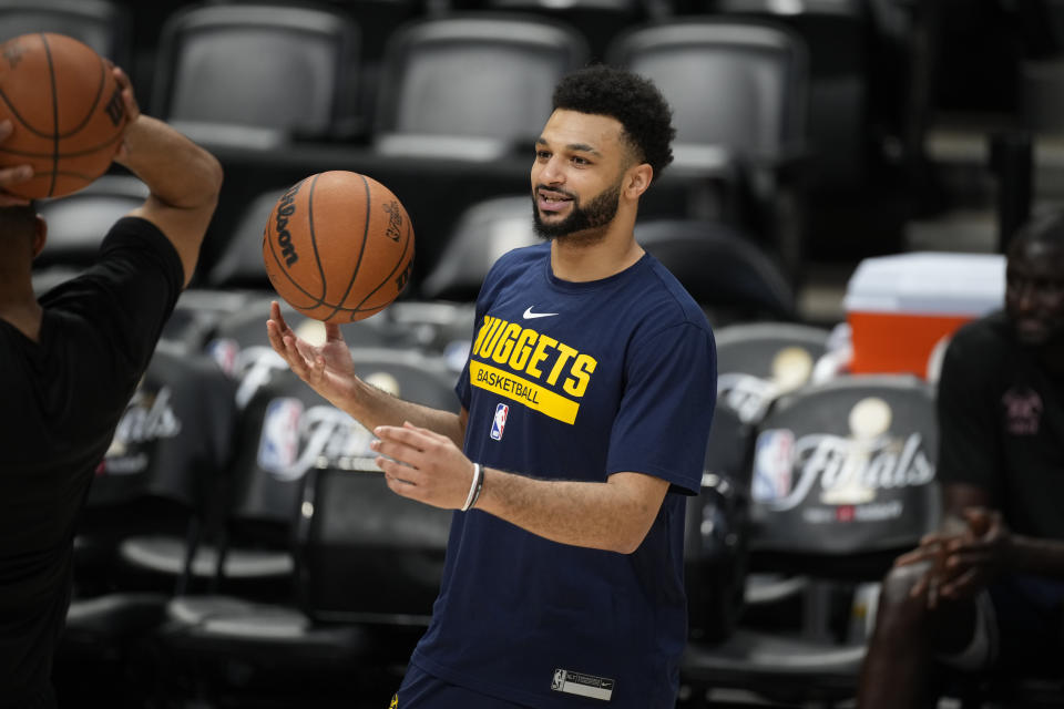 Denver Nuggets guard Jamal Murray jokes with teammates during practice for Game 2 of the NBA Finals, Saturday, June 3, 2023, in Denver. (AP Photo/David Zalubowski)