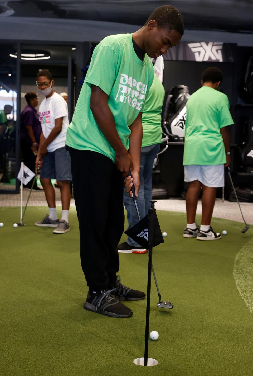 Doryian Kirkwood, 15, putts during the one-day DAPCEP camp at PXG (Parsons Extreme Golf) in Troy on July 27, 2022. Nineteen students from the metro Detroit school learned the science and engineering of golf from the clubs to ball striking.