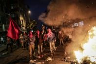 Left wing protesters shout slogans and hold red flag during a demonstration denouncing a police operation against Kurdish militants, on July 24, 2015 at Gazi district in Istanbul