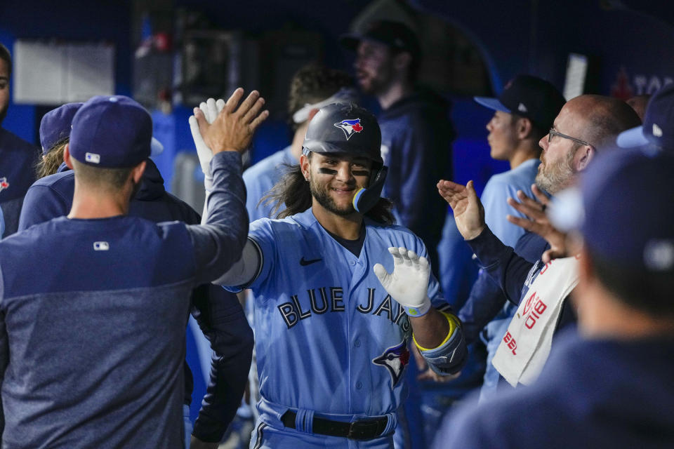 Toronto Blue Jays shortstop Bo Bichette (11) celebrates his home run against the Chicago White Sox during the seventh inning of a baseball game in Toronto, Wednesday, April 26, 2023. (Andrew Lahodynskyj/The Canadian Press via AP)