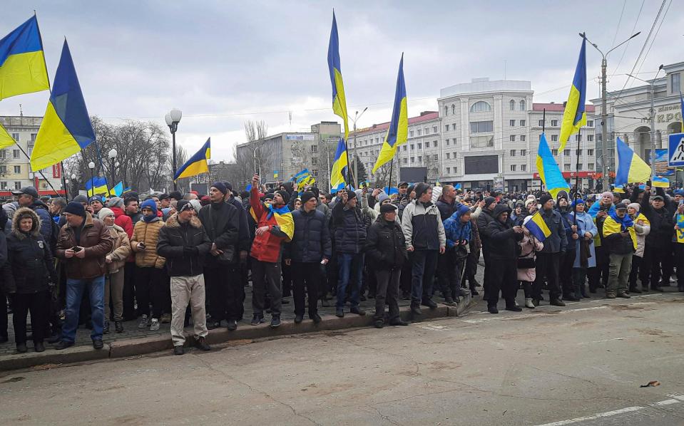 The residents of Kherson protest on the streets, waving Ukrainian flags, after Russian forces occupied the city in early March - AP Photo/Olexandr Chornyi