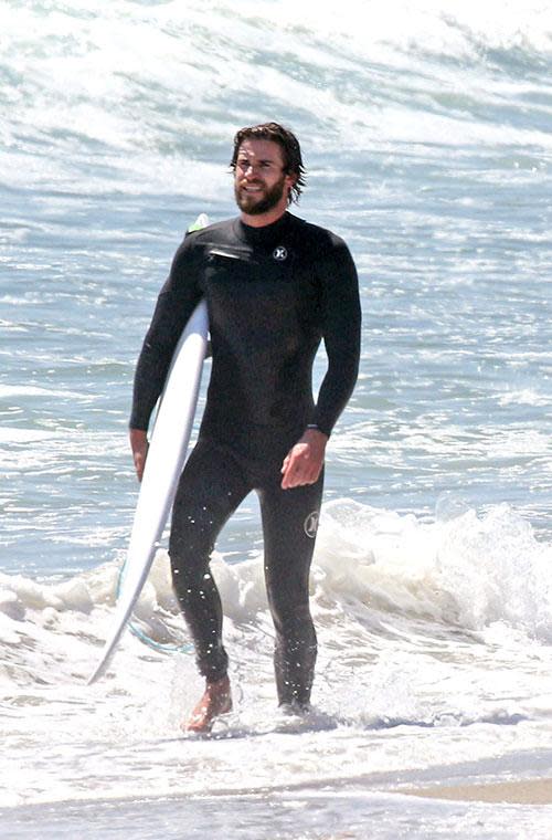 Liam Hemsworth bares all before a day in the surf