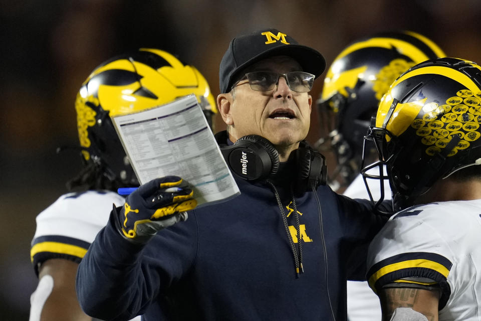 FILE - Michigan head coach Jim Harbaugh stands on the field during the first half of an NCAA college football game against Minnesota Saturday, Oct. 7, 2023, in Minneapolis. The NCAA banned in-person advanced scouting in 1994 in part because not every school could afford to do it. Now Michigan is being investigated by the NCAA for a sign-stealing scheme that allegedly involved people secretly being sent to record opponents’ games. No. 2 Michigan and the Big Ten acknowledged the investigation Thursday, Oct. 19, 2023. (AP Photo/Abbie Parr, File)