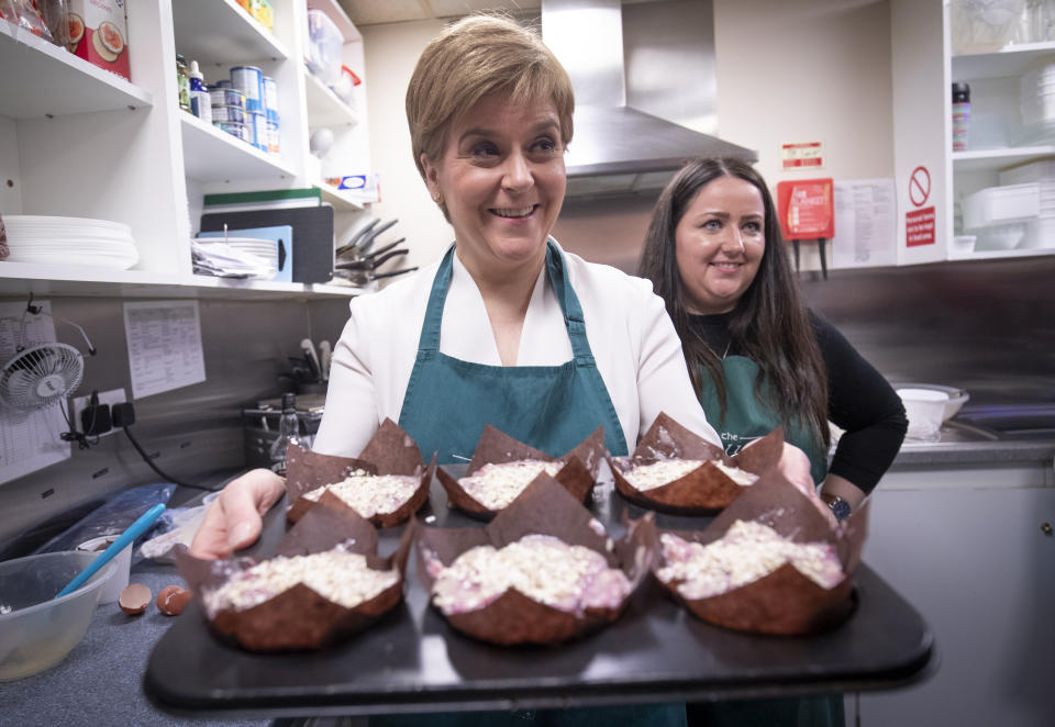 SNP leader Nicola Sturgeon with Angela Crawley (right), SNP Candidate for Lanark and Hamilton East, helps to make muffins during a visit the Wallace tea Rooms in Lanark on the General Election campaign trail.