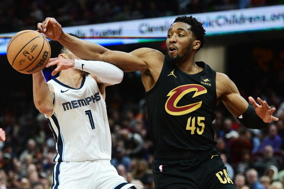 Apr 10, 2024; Cleveland, Ohio, USA; Cleveland Cavaliers guard Donovan Mitchell (45) knocks the ball away from Memphis Grizzlies guard Scotty Pippen Jr. (1) during the second half at Rocket Mortgage FieldHouse. Mandatory Credit: Ken Blaze-USA TODAY Sports