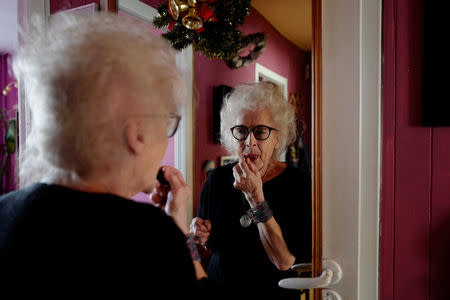 DJ Wika Szmyt, 80, puts make-up at her home before leaving to play music at a club in Warsaw, Poland March 25, 2019. Picture taken March 25, 2019. REUTERS/Kacper Pempel