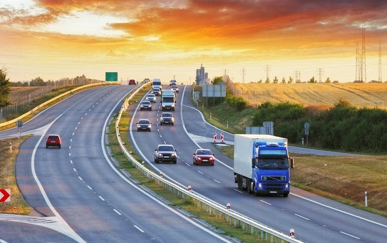 Trucks and cars on a major road.