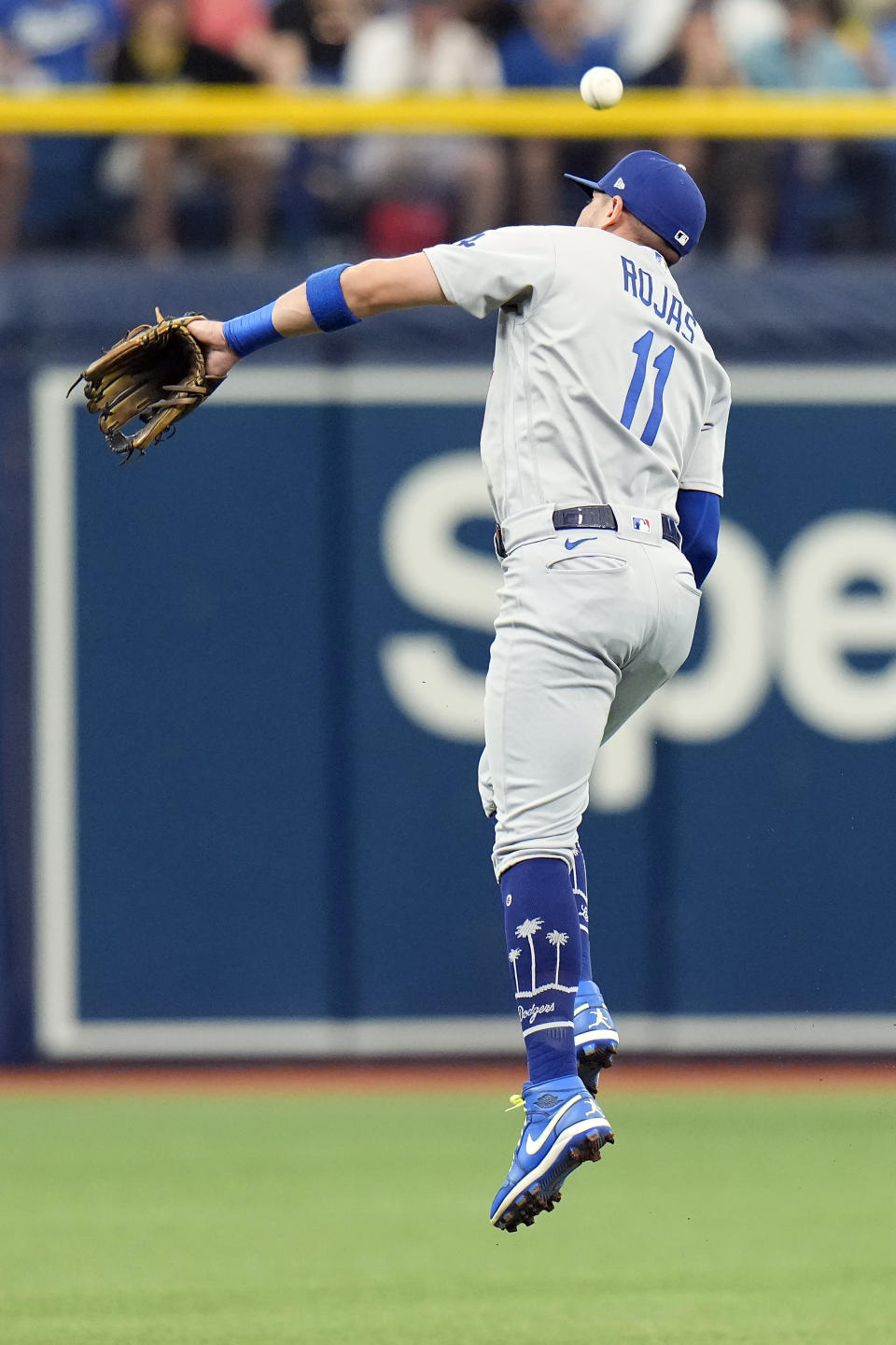 Los Angeles Dodgers shortstop Miguel Rojas (11) leaps but can't get a single by Tampa Bay Rays' Wander Franco during the first inning of a baseball game Sunday, May 28, 2023, in St. Petersburg, Fla. (AP Photo/Chris O'Meara)