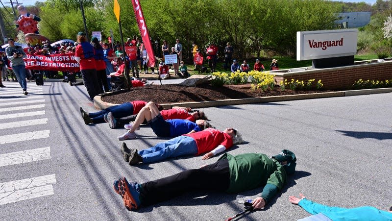 People lay down on the ground during the Vanguard SOS Campaign Fight For Our Future: Rally For Climate, Care, Jobs & Justice on April 22, 2022 in Malvern, Pennsylvania.