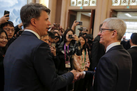 Apple CEO Tim Cook and BMW's Chairman of the Board of Management Harald Krueger attend the China Development Forum in Beijing, China March 23, 2019. REUTERS/Thomas Peter