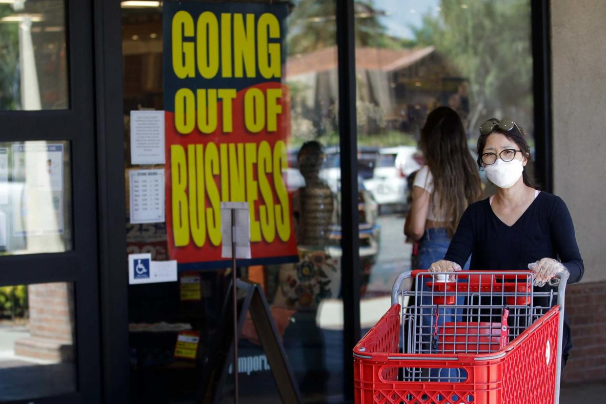 A shopper walks past a Pier 1 Imports store as going out of business signs are posted amid the coronavirus pandemic in Santa Clarita, California: AP
