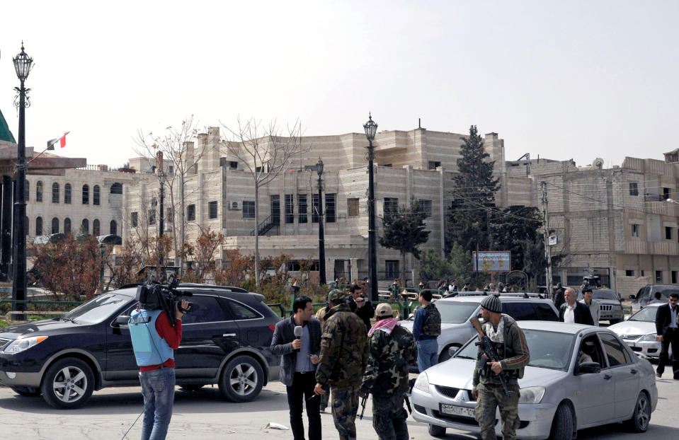 This photo released by the Syrian official news agency SANA, shows Syrian forces loyal to Syrian President Bashar Assad being deployed in the town of Yabroud, Syria, Sunday, March 16, 2014. Syrian troops backed by Hezbollah fighters seized a key rebel supply town on the Lebanese border on Sunday, driving them from the area and scoring a major blow against them in the three-year-old-conflict. (AP Photo/SANA)