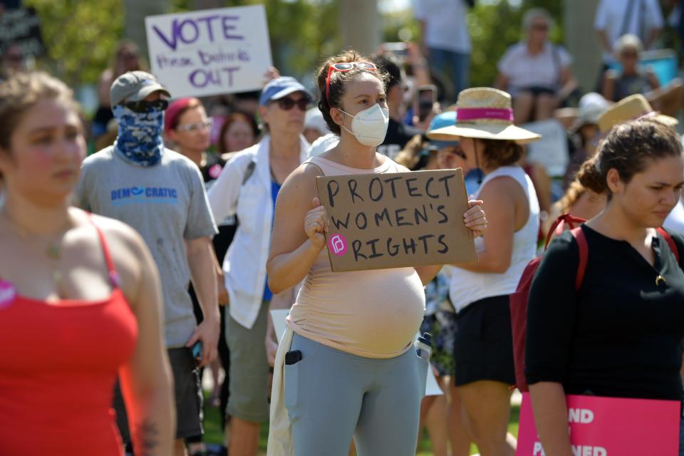 Maddie Dugan of West Palm Beach attends an abortion-rights rally and march sponsored by the League of Women Voters held at the Meyer Amphitheater in downtown West Palm Beach on Saturday, May 14, 2022.