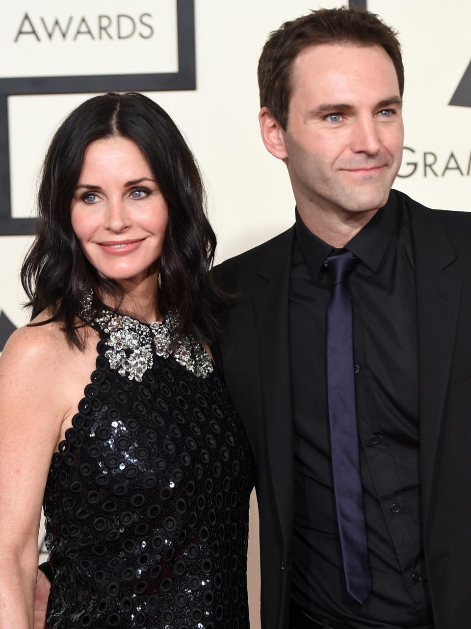 Courteney Cox (L) and songwriter Johnny McDaid attend The 57th Annual GRAMMY Awards at the STAPLES Center on February 8, 2015 in Los Angeles, California