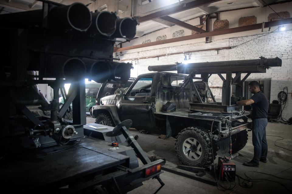 Ukrainian civilian volunteers work to modify damaged and salvaged vehicles into small mobile MLRS (Multiple Launch Rocket System) units made from recovered Russian and Ukrainian military hardware on September 25, 2023, in Zaporizhzhia, Ukraine.