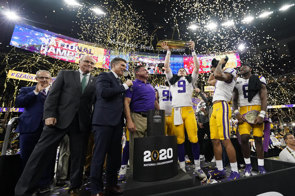 LSU quarterback Joe Burrow holds the trophy after their win against Clemson in a NCAA College Football Playoff national championship game Monday, Jan. 13, 2020, in New Orleans. LSU won 42-25. (AP Photo/David J. Phillip)