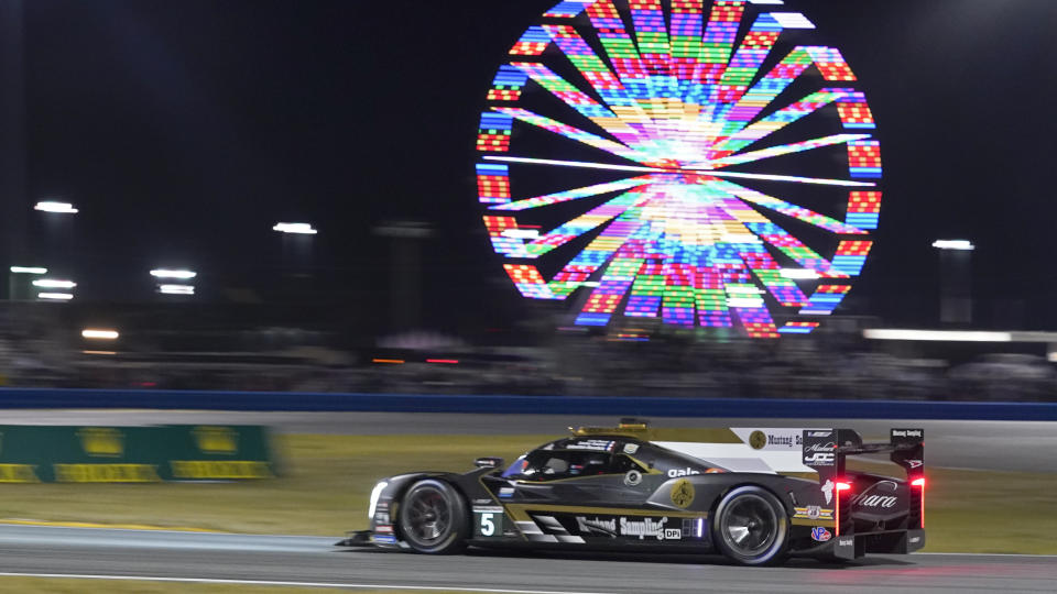 Tristain Vautier, of France, drives the Cadillac DPi into the east horseshoe turn during the Rolex 24 hour auto race at Daytona International Speedway, Saturday, Jan. 30, 2021, in Daytona Beach, Fla. (AP Photo/John Raoux)