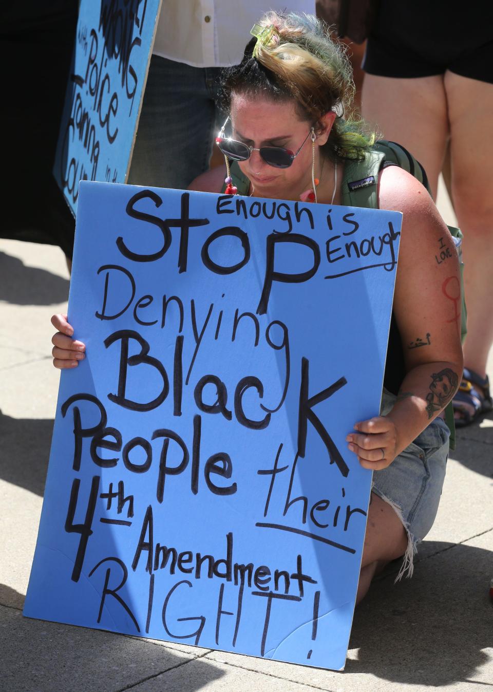 Athena Brown becomes emotional as demonstrators gather Saturday at the Stubbs Justice Center in downtown Akron.