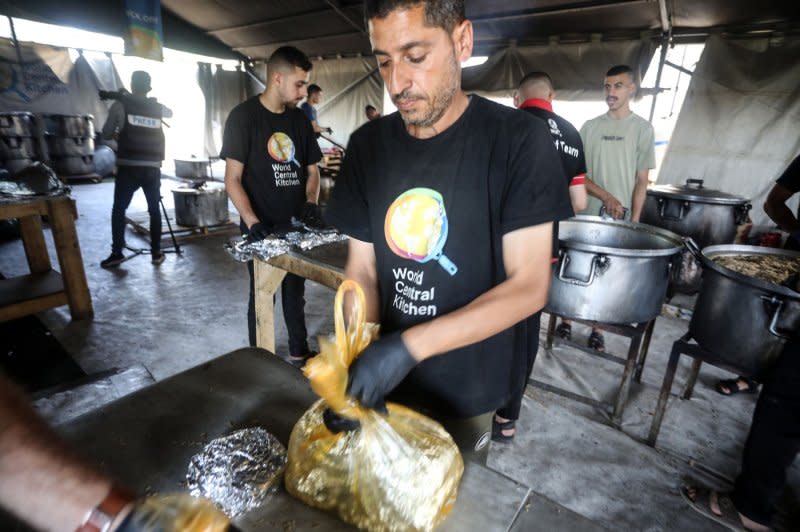 Local volunteers for the US-based aid group World Central Kitchen prepare food to be distributed to needy Palestinians in Rafah in the southern Gaza Strip, on Friday, May 3, 2024. Seven World Central Kitchen workers were killed in an Israeli airstrike in Gaza in April. Photo by Ismael Mohamad/UPI