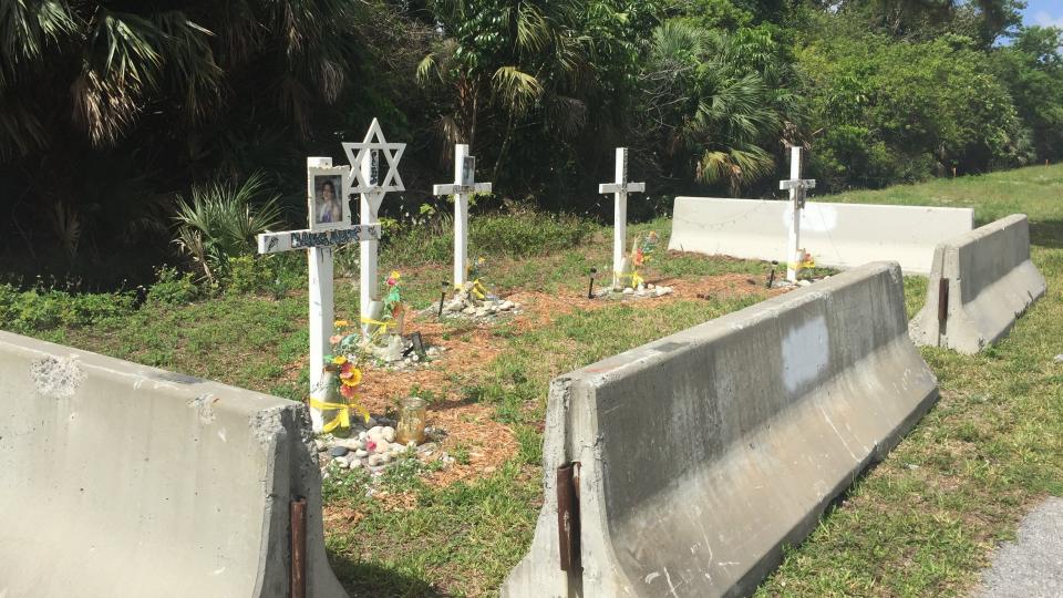 A memorial that included four crosses, one Star of David, photos of the five children and mementos that the families and friends of the victims arranged after a 1996 two-car wreck was inadvertently removed by the county on Wednesday.